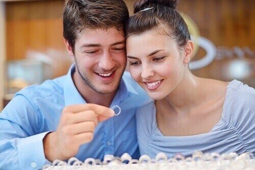 Couple looking at engagement ring