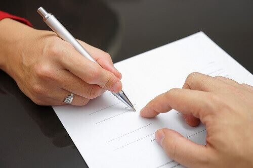 Person signing prenuptial agreement
